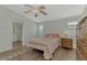 Main bedroom with a queen bed, dresser, and ensuite bathroom access at 552 Fleetwood St, North Port, FL 34287