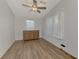 Spacious bedroom with a dresser and large windows, showcasing light wood flooring at 552 Fleetwood St, North Port, FL 34287