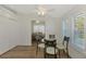 Bright dining area with glass table and chairs, adjacent to kitchen at 552 Fleetwood St, North Port, FL 34287