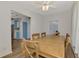 Rustic wooden dining table with six chairs in bright dining room at 552 Fleetwood St, North Port, FL 34287
