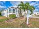 Side view of a white mobile home and landscaping at 552 Fleetwood St, North Port, FL 34287
