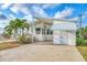 Front view of a white mobile home with palm trees at 552 Fleetwood St, North Port, FL 34287