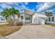 White mobile home with carport and landscaped yard at 552 Fleetwood St, North Port, FL 34287