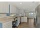White kitchen with stainless steel appliances and built-in desk area at 552 Fleetwood St, North Port, FL 34287