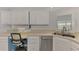 White kitchen with corner sink, stainless steel appliances and built-in desk at 552 Fleetwood St, North Port, FL 34287