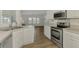 Modern kitchen with stainless steel appliances and white cabinets at 552 Fleetwood St, North Port, FL 34287