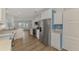 Open concept kitchen with stainless steel appliances and white cabinets at 552 Fleetwood St, North Port, FL 34287