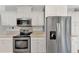 Modern kitchen featuring stainless steel appliances and white cabinets at 552 Fleetwood St, North Port, FL 34287