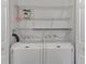 Laundry room with washer, dryer, and ample shelving at 552 Fleetwood St, North Port, FL 34287