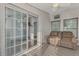 Bright sunroom features a comfy couch, ceiling fan, and sliding glass doors at 552 Fleetwood St, North Port, FL 34287