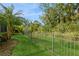 Private backyard with lush landscaping and fence at 5592 Semolino St, Nokomis, FL 34275