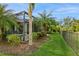 Landscaped backyard with a pool and privacy fence at 5592 Semolino St, Nokomis, FL 34275