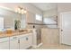 Spa-like bathroom with walk-in shower, double vanity, and granite countertop at 5592 Semolino St, Nokomis, FL 34275