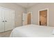 Cozy bedroom with ensuite bathroom and double doors at 5592 Semolino St, Nokomis, FL 34275