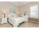 Bright bedroom featuring a comfortable bed and white nightstands at 5592 Semolino St, Nokomis, FL 34275