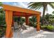 Relaxing cabana with lounge chairs and shade curtains at 5592 Semolino St, Nokomis, FL 34275