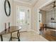 Bright entryway with tile flooring, a half-wall, and built-in shelving at 5592 Semolino St, Nokomis, FL 34275