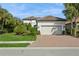 House exterior with landscaping and brick driveway at 5592 Semolino St, Nokomis, FL 34275