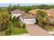 Single-story home with tile roof, driveway, and landscaping at 5592 Semolino St, Nokomis, FL 34275