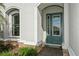 Inviting front entrance with a green door and welcoming mat at 5592 Semolino St, Nokomis, FL 34275