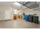 Garage with overhead storage and ample space for cars at 5592 Semolino St, Nokomis, FL 34275
