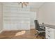 Bright home office featuring built-in shelving and hardwood floors at 5592 Semolino St, Nokomis, FL 34275