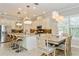 Elegant kitchen featuring white cabinets, breakfast bar and dining area at 5592 Semolino St, Nokomis, FL 34275