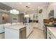 Modern kitchen with a large island, stainless steel appliances, and granite countertops at 5592 Semolino St, Nokomis, FL 34275