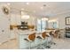 Modern kitchen with white cabinets, granite counters, and an island at 5592 Semolino St, Nokomis, FL 34275