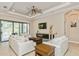 Spacious living room with fireplace and access to the backyard at 5592 Semolino St, Nokomis, FL 34275