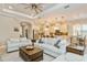 Open-concept living area with comfortable seating and a kitchen view at 5592 Semolino St, Nokomis, FL 34275