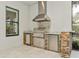 This outdoor kitchen boasts stainless steel appliances and a stone facade at 5592 Semolino St, Nokomis, FL 34275