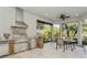 Stainless steel appliances and stone finishes feature in this outdoor kitchen at 5592 Semolino St, Nokomis, FL 34275