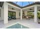 Covered patio with outdoor kitchen and seating area at 5592 Semolino St, Nokomis, FL 34275