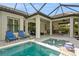 Resort-style pool and spa with outdoor kitchen and dining at 5592 Semolino St, Nokomis, FL 34275