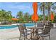 Seating area with table and chairs near the community pool at 5592 Semolino St, Nokomis, FL 34275