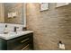 Stylish powder room with modern vanity and elegant wallcovering at 5592 Semolino St, Nokomis, FL 34275