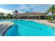 Community pool with expansive deck and lounge chairs at 5592 Semolino St, Nokomis, FL 34275