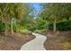 Curving walkway through a landscaped park-like setting at 5592 Semolino St, Nokomis, FL 34275