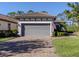 Single-story home with gray garage door and paver driveway at 5733 Semolino St, Nokomis, FL 34275