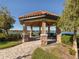 Lakeside gazebo with stonework and a bench at 5733 Semolino St, Nokomis, FL 34275