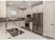 Kitchen boasts stainless steel appliances and white cabinetry at 5733 Semolino St, Nokomis, FL 34275