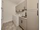 Bright laundry room with modern cabinets and tile floor at 5733 Semolino St, Nokomis, FL 34275