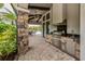 Outdoor kitchen with grill and stone accents at 5733 Semolino St, Nokomis, FL 34275