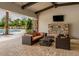 Relaxing poolside patio with fireplace and seating at 5733 Semolino St, Nokomis, FL 34275