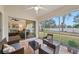 Spacious screened porch with view of backyard and living room at 6228 Country Club Way, Sarasota, FL 34243