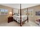 Bedroom with four-poster bed and window shutters at 649 Tamiami S Trl # 107, Venice, FL 34285