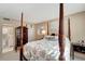 Bedroom with four-poster bed and barn door to bathroom at 649 Tamiami S Trl # 107, Venice, FL 34285