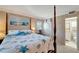 Bright bedroom with a four-poster bed and barn door at 649 Tamiami S Trl # 107, Venice, FL 34285