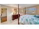 Spacious bedroom with a four-poster bed and ensuite access at 649 Tamiami S Trl # 107, Venice, FL 34285